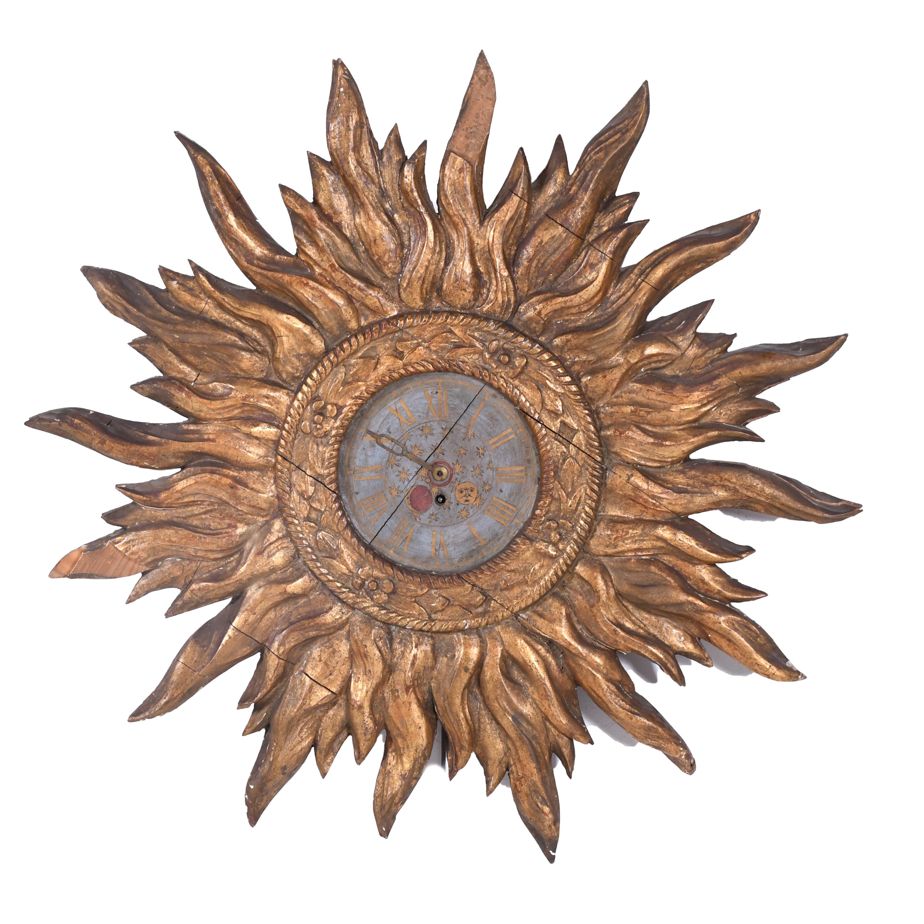 SUN-SHAPED CARVED CLOCK, EARLY 20TH CENTURY. 