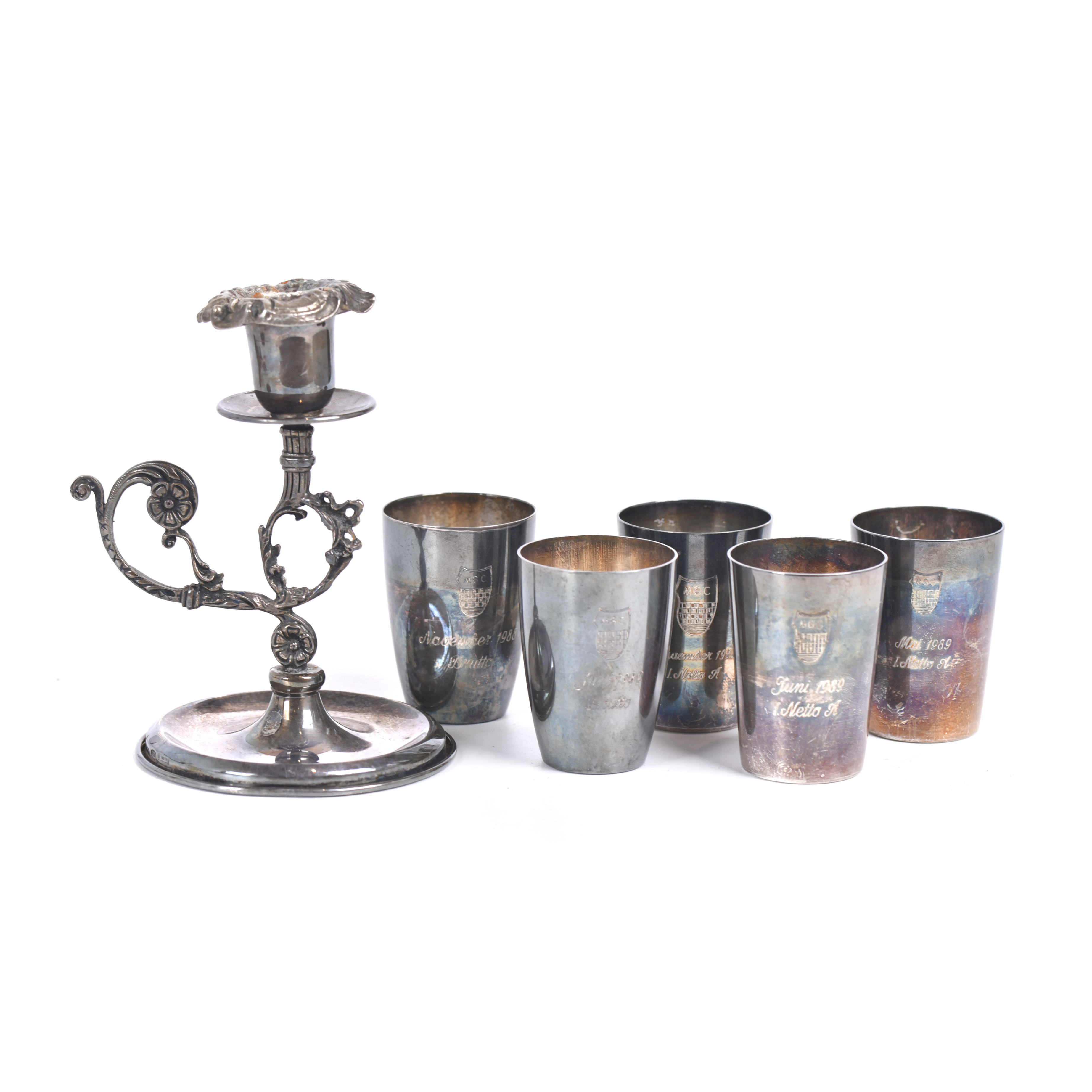 Set of five vessels and a candlestick in silver.