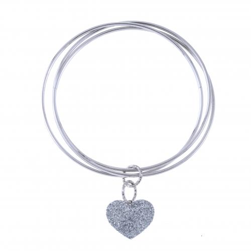 GROUP OF THREE BANGLE BRACELETS WITH A HEART.