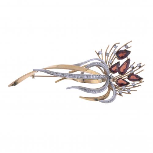 FLORAL BROOCH WITH GARNETS AND DIAMONDS.