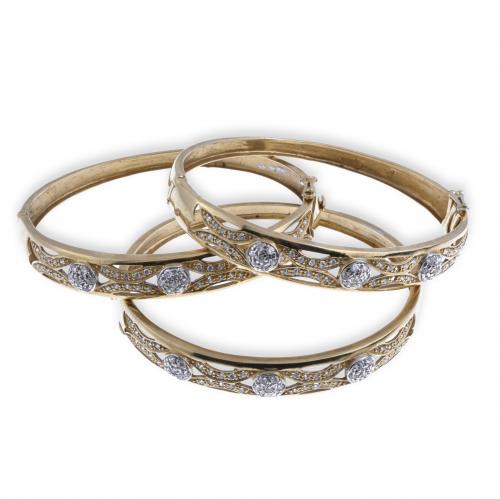 THREE BANGLE BRACELETS WITH ZIRCONS.