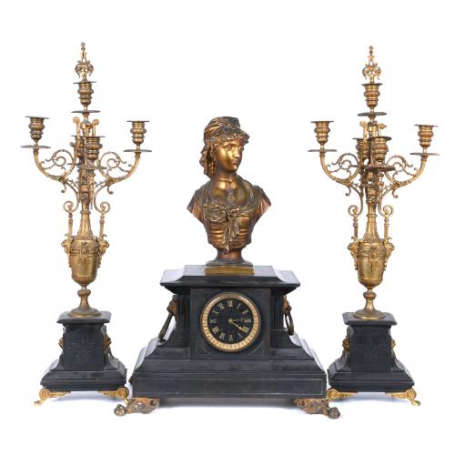 TABLE CLOCK WITH BARCELONA-STYLE DECORATION CONSISTING OF A CLOCK AND A PAIR OF CANDELABRA.