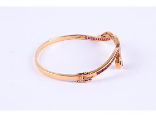 SNAKE-SHAPED BANGLE BRACELET WITH RUBIES AND DIAMONDS.