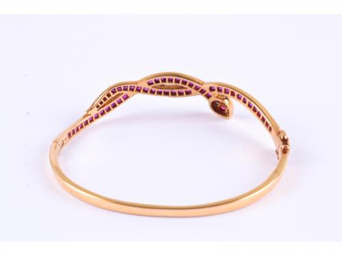 SNAKE-SHAPED BANGLE BRACELET WITH RUBIES AND DIAMONDS.