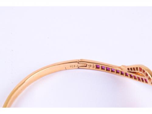 SNAKE-SHAPED BANGLE BRACELET WITH RUBIES AND DIAMONDS.