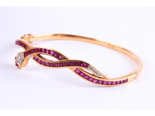 SNAKE-SHAPED BANGLE BRACELET WITH RUBIES AND DIAMONDS.