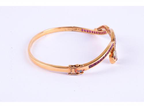 SNAKE-SHAPED BANGLE BRACELET WITH RUBIES AND DIAMONDS.