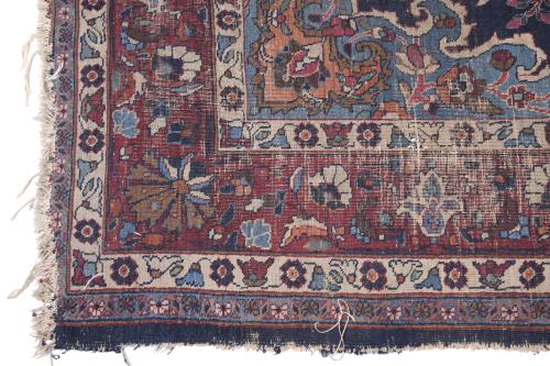 PERSIAN CARPET IN REDDISH AND BLUISH TONES.